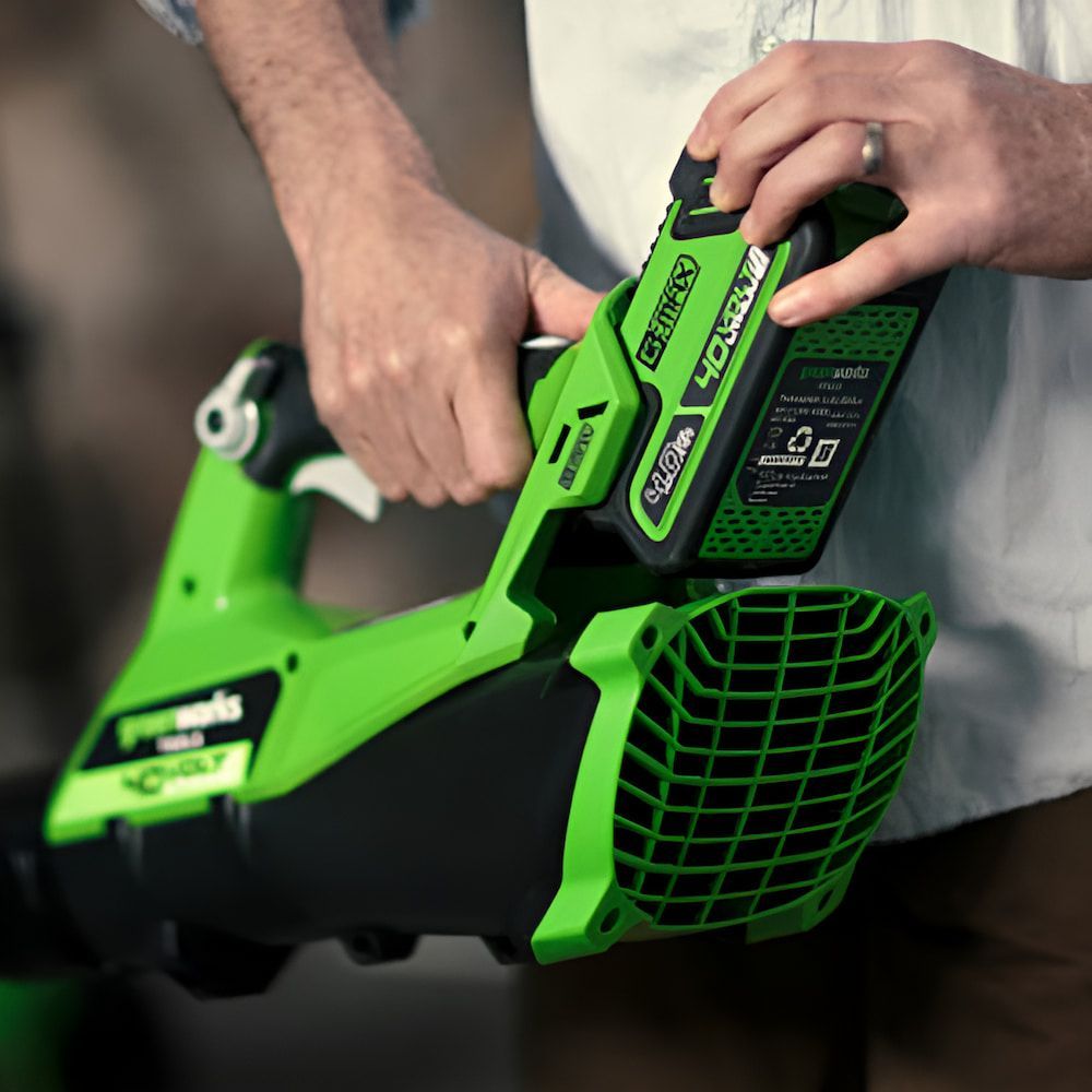 A Person is Holding a Green Blower That Says Greenworks on It — Mackay Kawasaki in North Mackay, QLD