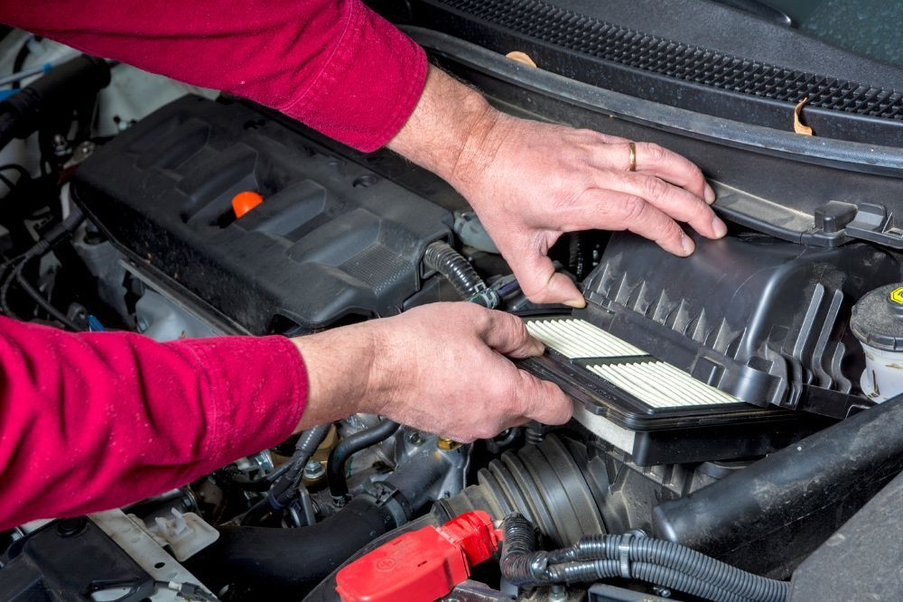 Mechanic taking out air filter | Elite Autocare of Princeton