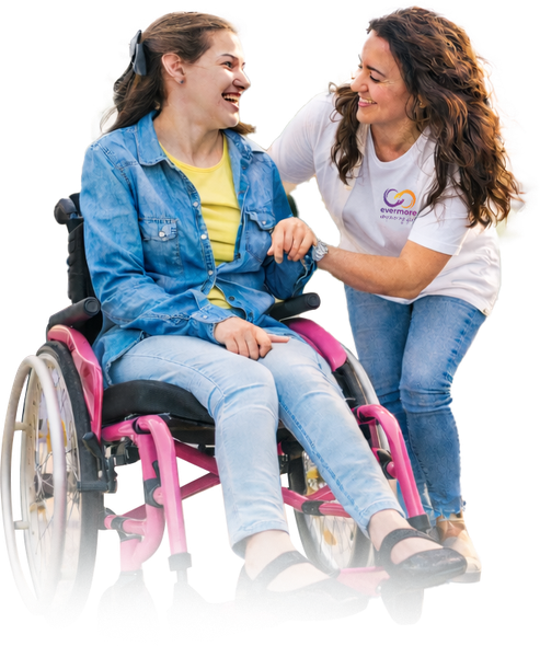 An Evermore disability services support worker assisting a young lady in a wheelchair
