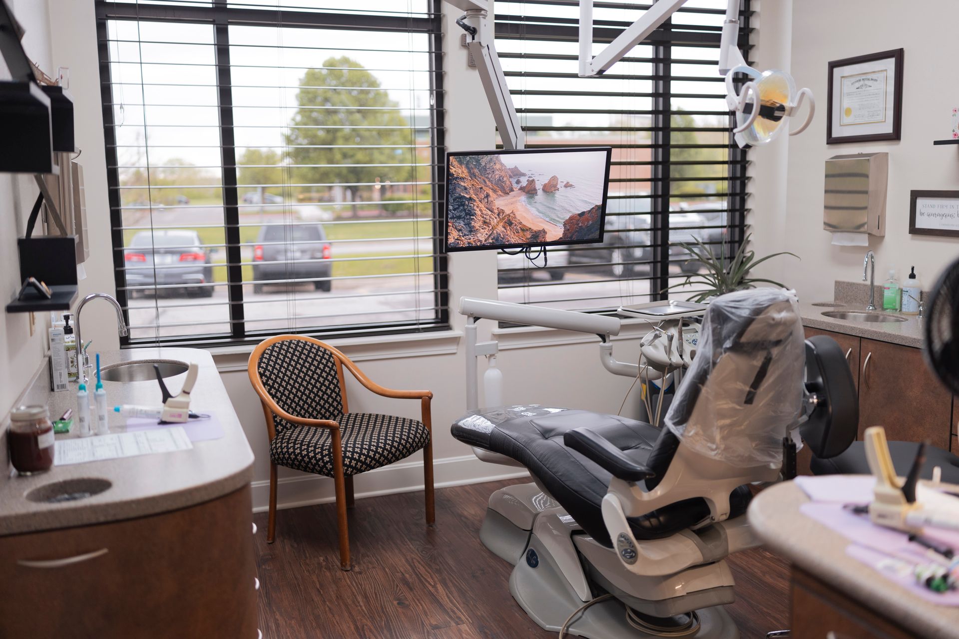 A waiting room with a couch , chairs , and a counter.