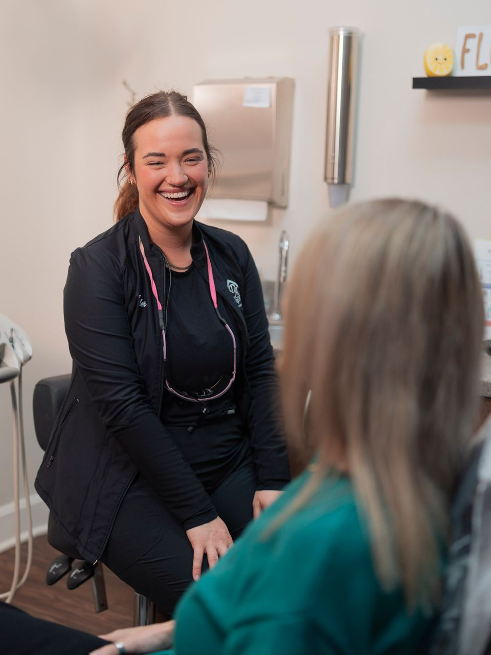 A woman is getting her teeth examined by a dentist