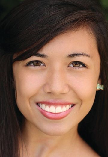 A close up of a woman 's face with a smile on her face