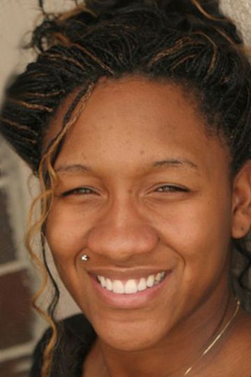 A close up of a woman 's face smiling with her eyes closed