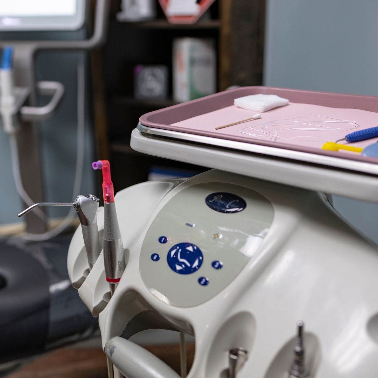 A dental chair with a tray on top of it