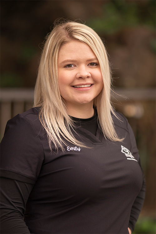 The woman is wearing a black shirt and smiling for the camera.