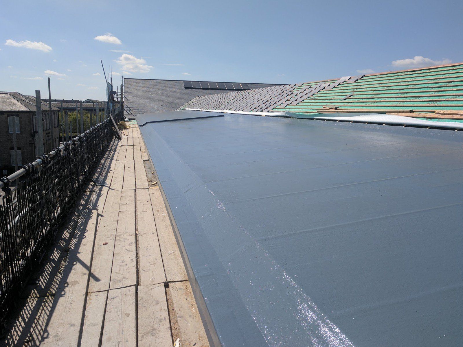 A roof is being built on top of a wooden scaffolding.