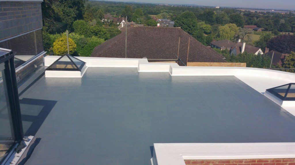 A rooftop with a view of a city and trees
