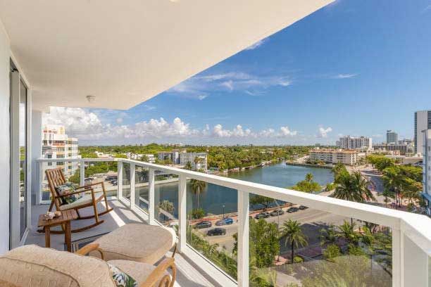 A balcony with a view of a lake and a city.