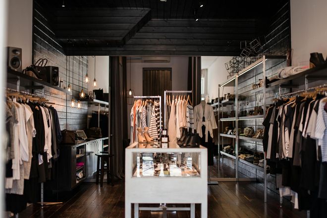 Modern beauty store interior with black and white displays, products, and overhead lighting.
