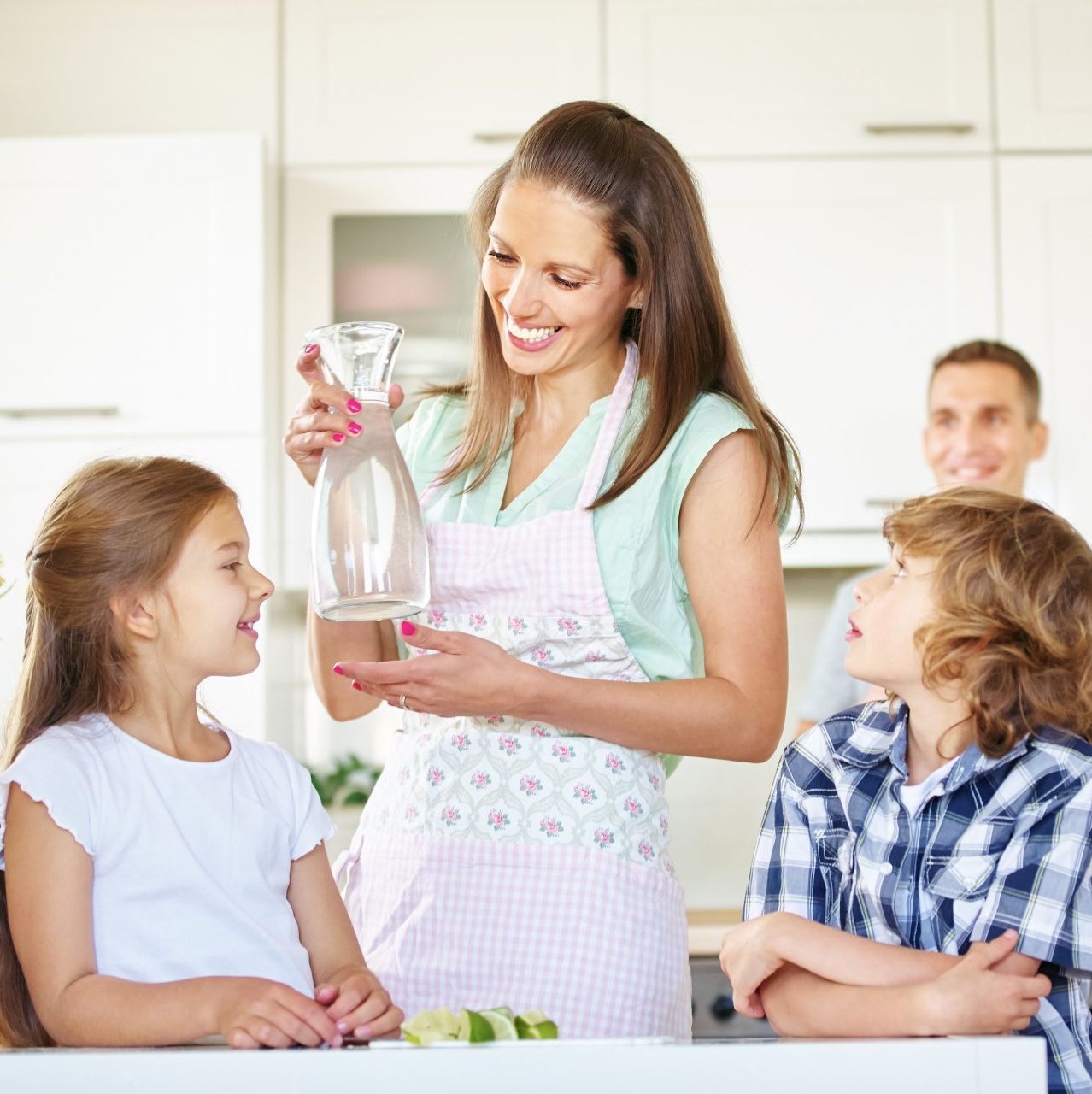 Woman drinking water with children
