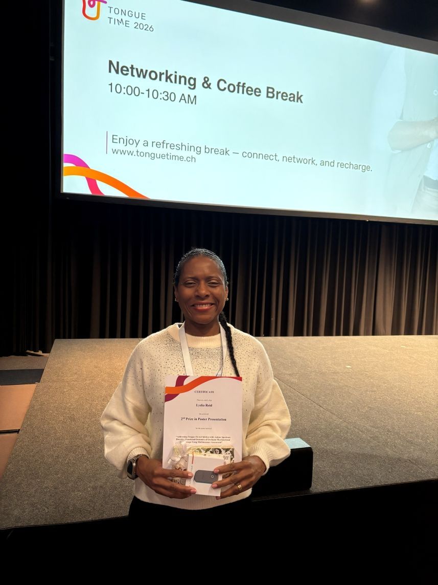 Person holding a certificate at a conference stage during a networking and coffee break