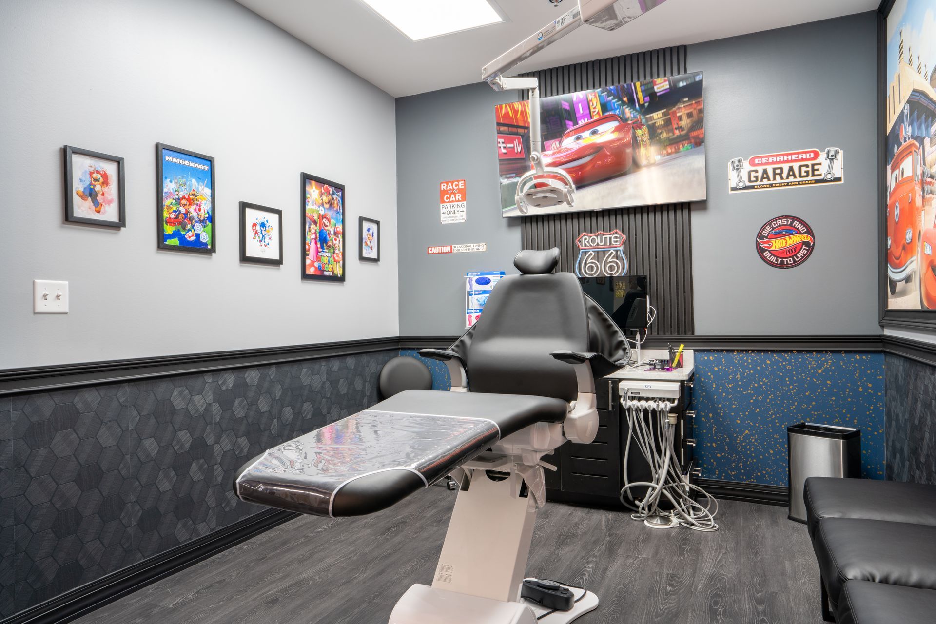 Tattoo studio with a reclining chair, framed art, and black-and-gray decor
