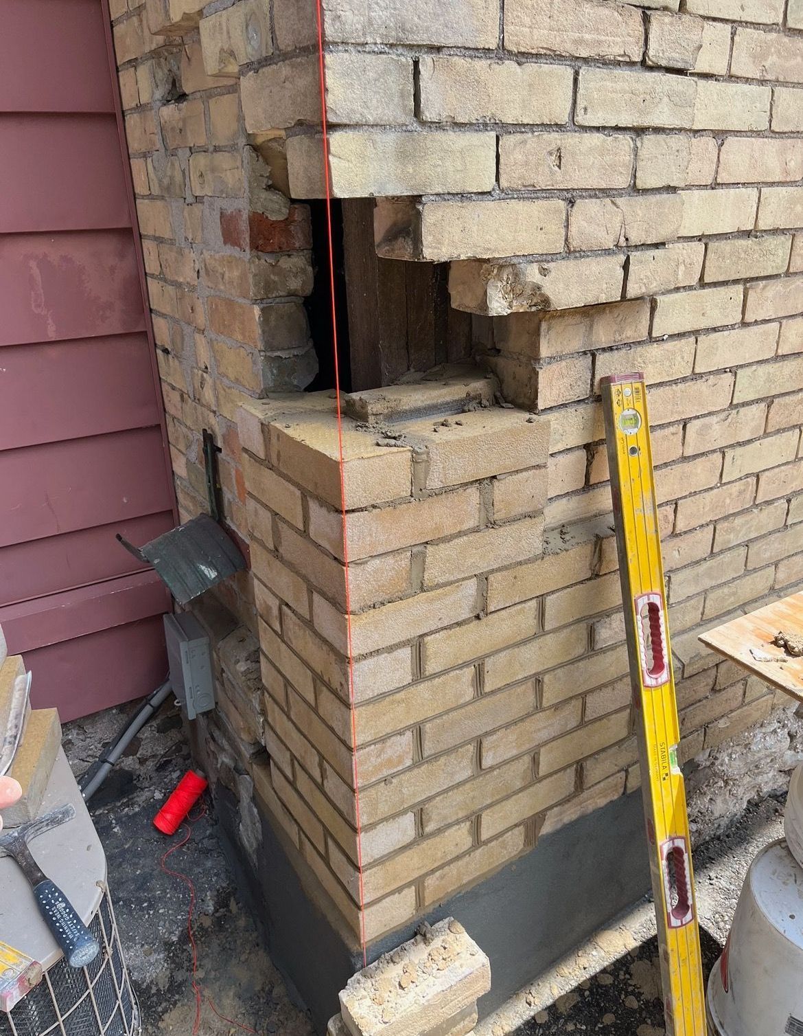 a before and after photo of a brick wall being repaired with a plow .