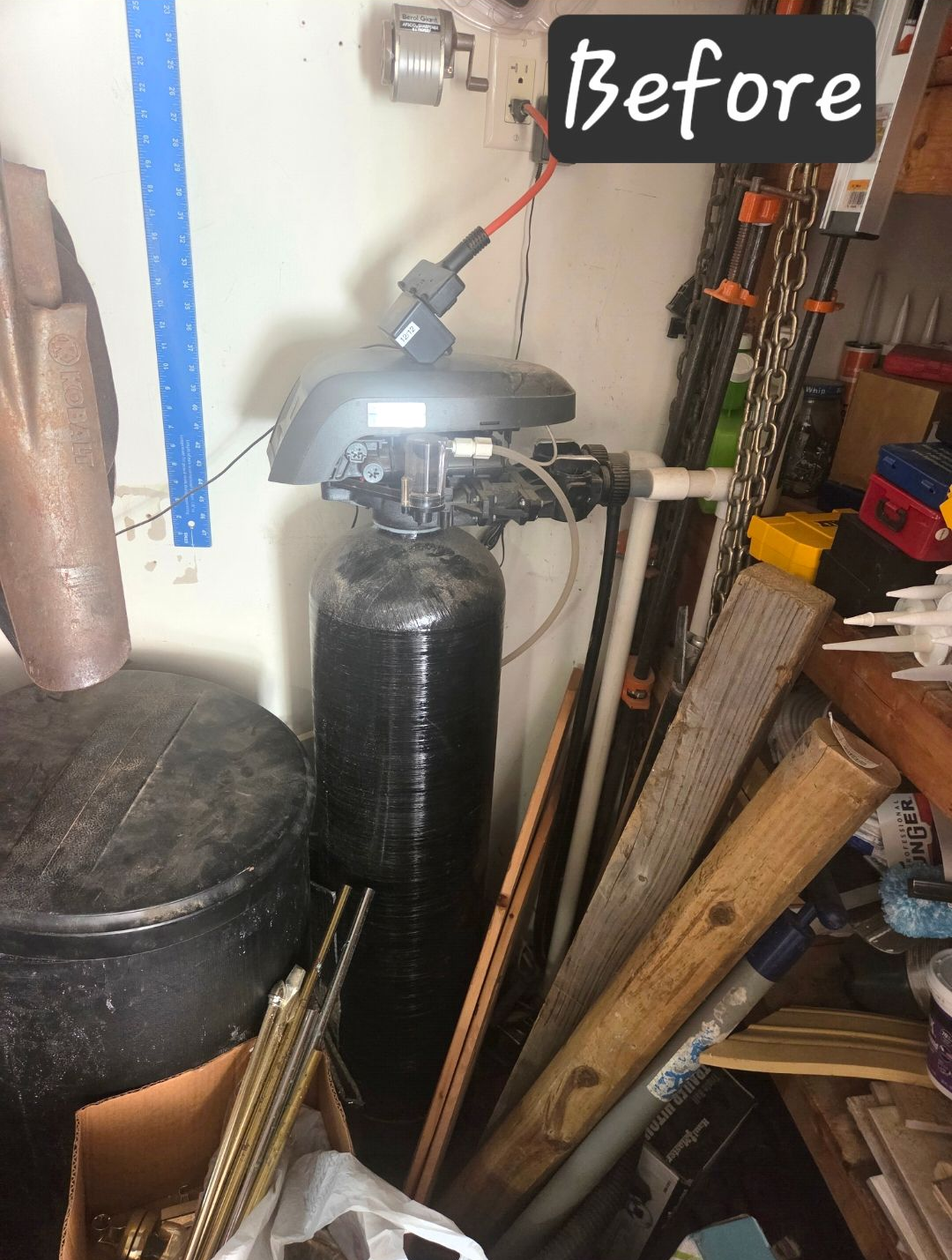 Before label over black water filtration in a cluttered workshop.