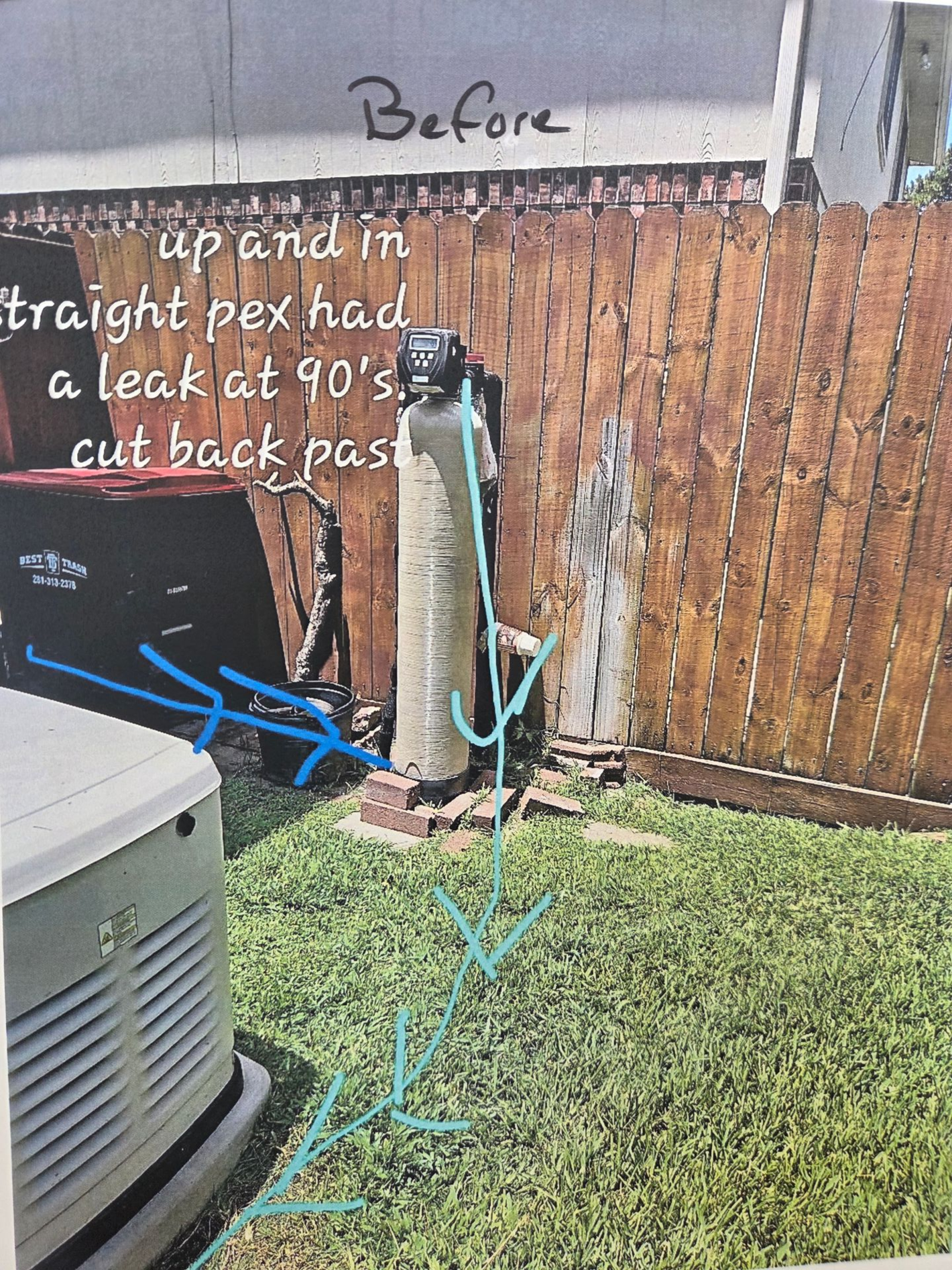 Backyard fence with water damage notes and blue arrows marked on grass and posts