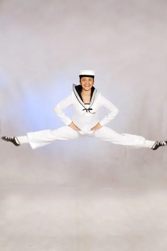 A Woman In A Sailor Costume Is Doing A Split In The Air — International Dance Affair In North Mackay, QLD