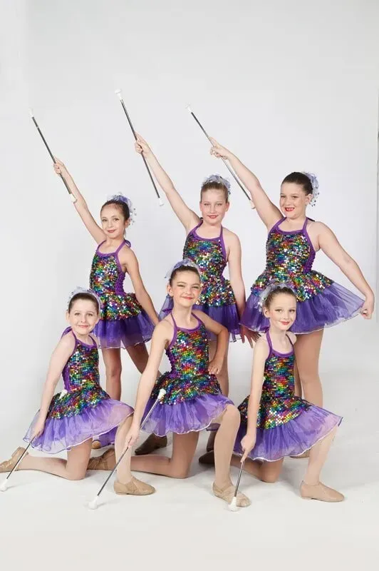 A Group Of Young Girls In Purple Dresses Are Holding Wands — International Dance Affair In North Mackay, QLD