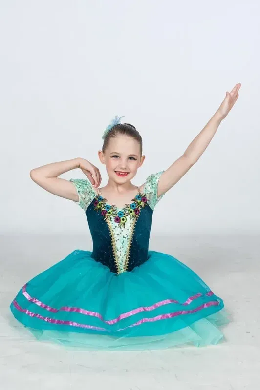 A Little Girl In A Blue Dress Is Sitting On The Floor — International Dance Affair In North Mackay, QLD