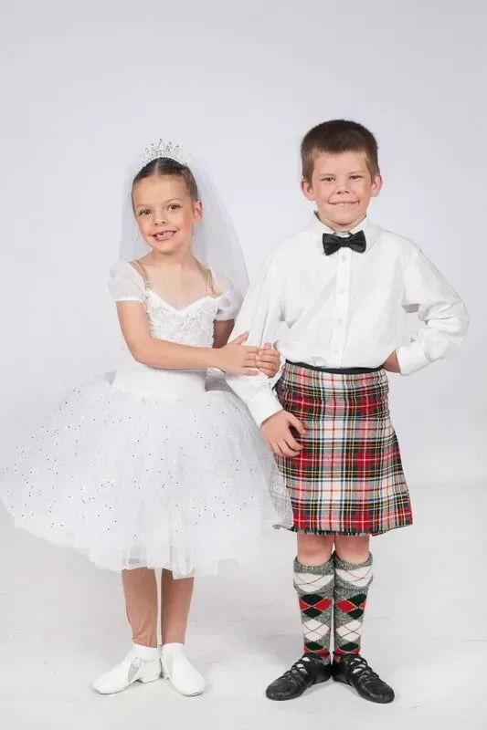 A Boy In A Kilt Is Standing Next To A Girl In A White Dress — International Dance Affair In North Mackay, QLD