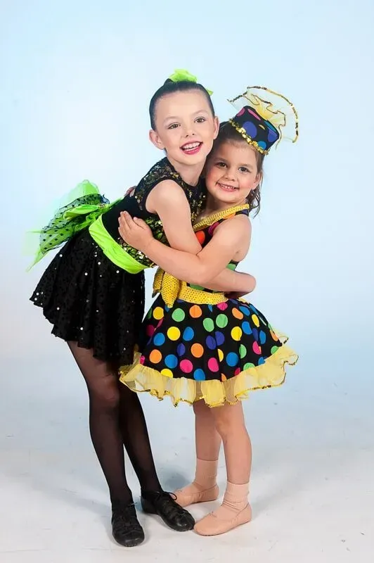 Two Little Girls In Colourful Costumes Are Hugging Each Other — International Dance Affair In North Mackay, QLD