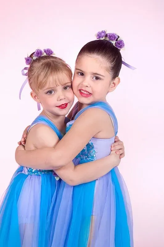 Two Little Girls In Blue Dresses Are Hugging Each Other — International Dance Affair In North Mackay, QLD