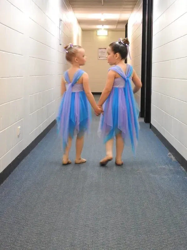 Two Little Girls In Blue And Purple Dresses Are Holding Hands In A Hallway — International Dance Affair In North Mackay, QLD