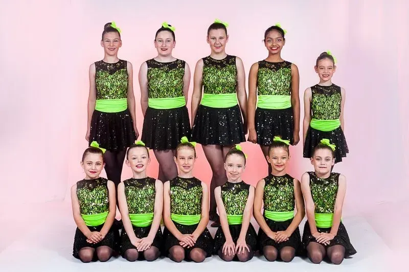 A Group Of Young Girls In Green And Black Dresses Are Posing For A Picture — International Dance Affair In North Mackay, QLD