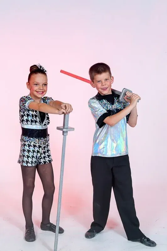 A Boy And A Girl Are Standing Next To Each Other Holding Plastic Swords — International Dance Affair In North Mackay, QLD