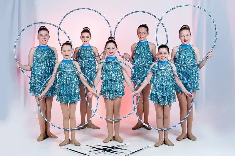 A Group Of Young Girls Are Standing Next To Each Other Holding Hula Hoops — International Dance Affair In North Mackay, QLD