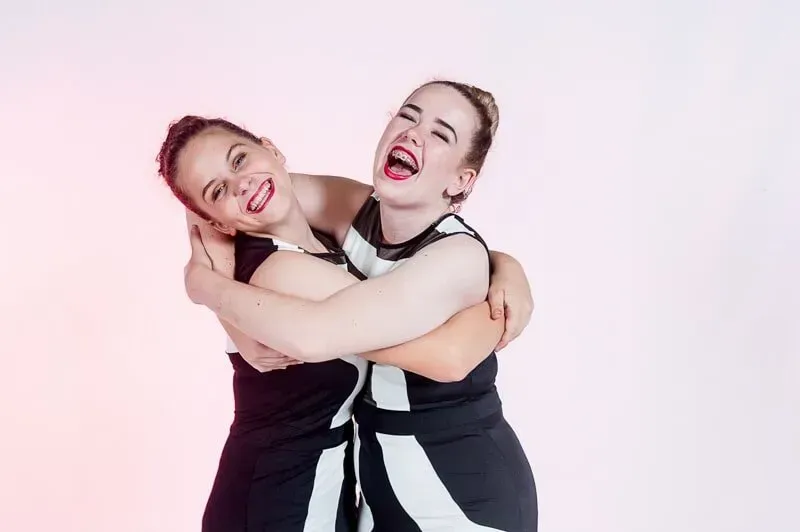 Two Women Are Hugging Each Other And Laughing — International Dance Affair In North Mackay, QLD