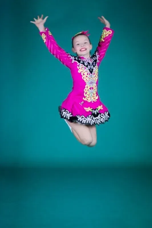 A Young Girl In A Pink Dress Is Jumping In The Air — International Dance Affair In North Mackay, QLD