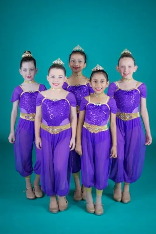 A Group Of Young Girls In Purple Costumes Are Standing Next To Each Other — International Dance Affair In North Mackay, QLD