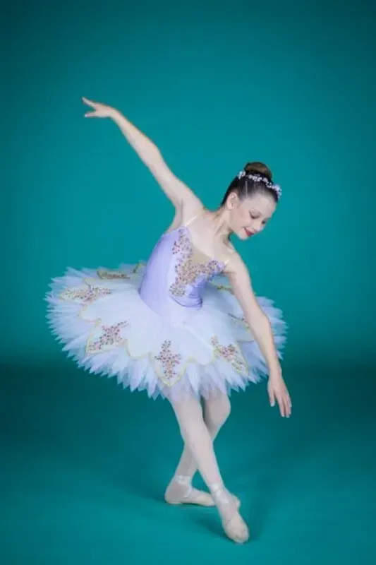 A Ballerina In A Purple And White Tutu Is Dancing On A Blue Background — International Dance Affair In North Mackay, QLD