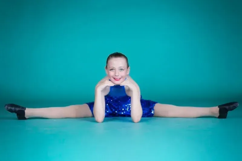 A Young Girl Is Doing Leg Split While Posing For A Picture — International Dance Affair In North Mackay, QLD