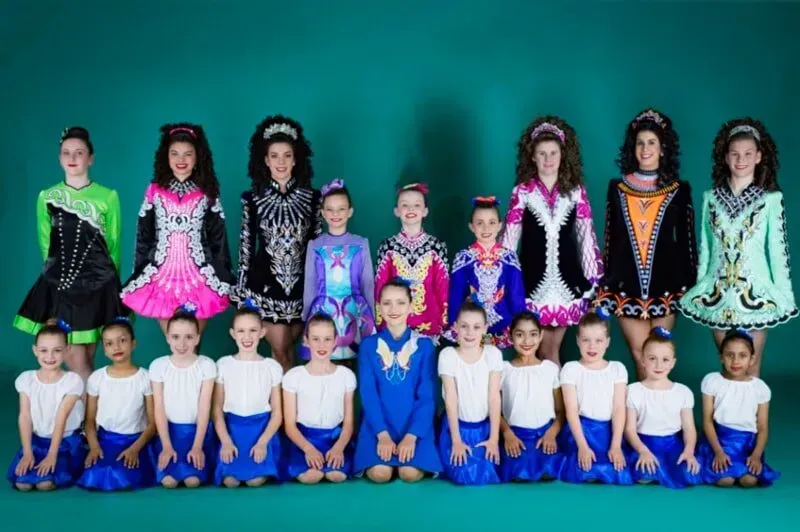 A Group Of Young Girls Are Posing For A Picture On A Blue Background — International Dance Affair In North Mackay, QLD