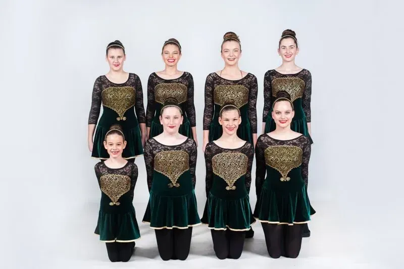 A Group Of Young Girls In Green And Black Dresses Are Posing For A Picture — International Dance Affair In North Mackay, QLD