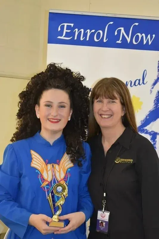 Two Women Standing In Front Of A Sign — International Dance Affair In North Mackay, QLD