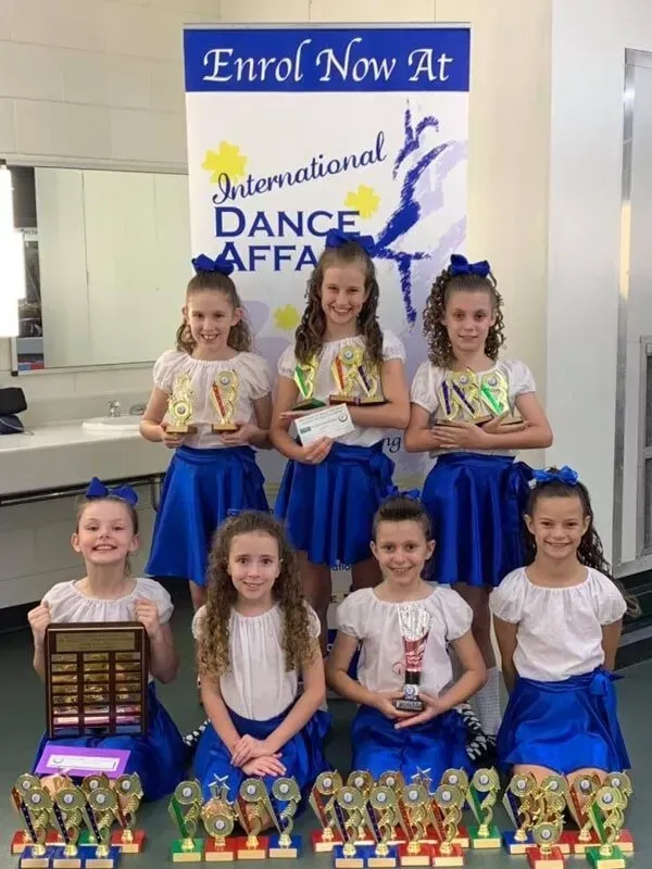 A Group Of Young Girls Holding Trophies — International Dance Affair In North Mackay, QLD
