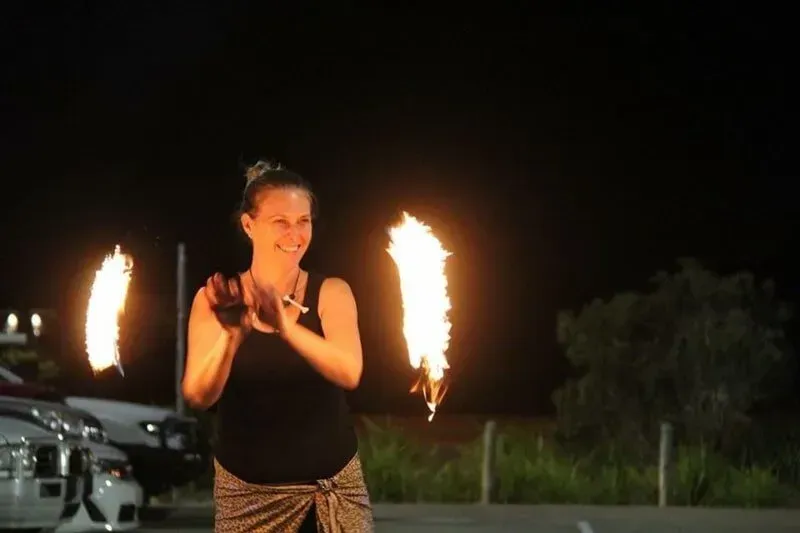 A Woman Is Holding A Pair Of Fire Torches In Her Hands — International Dance Affair In North Mackay, QLD