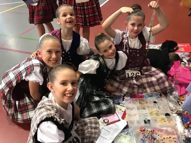 A Group Of Young Girls In Plaid Dresses Are Posing For A Picture — International Dance Affair In North Mackay, QLD