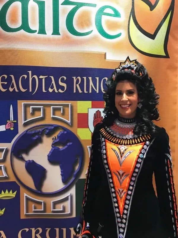 A Woman Stands In Front Of A Banner — International Dance Affair In North Mackay, QLD