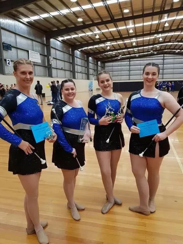 A Group Of Women Are Standing In A Gym Holding Trumpets — International Dance Affair In North Mackay, QLD