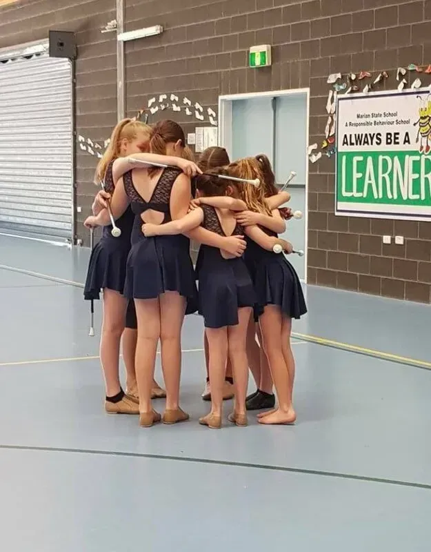 A Group Of Young Girls Are Hugging Each Other In A Gym — International Dance Affair In North Mackay, QLD