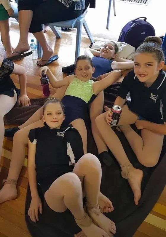 A Group Of Young Girls Are Laying On A Bean Bag Chair — International Dance Affair In North Mackay, QLD