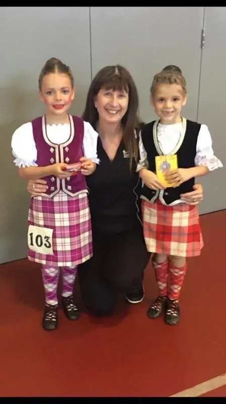 A Woman Is Posing For A Picture With Two Little Girls Wearing Kilts — International Dance Affair In North Mackay, QLD