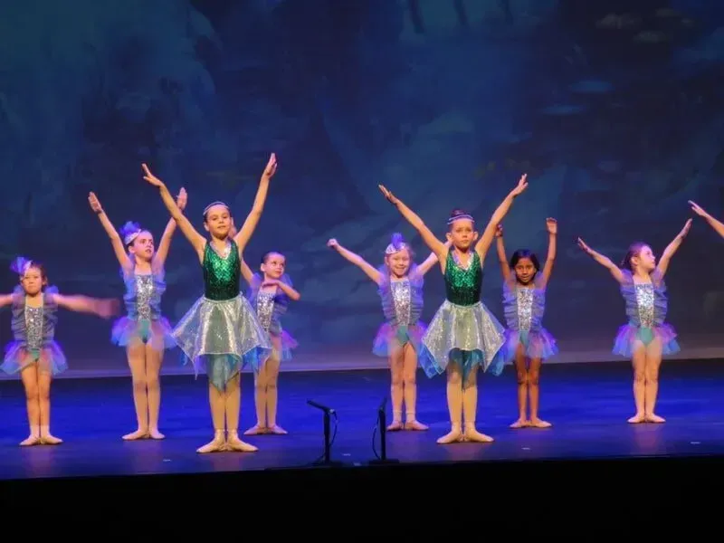 A Group Of Young Girls Are Dancing On A Stage With Their Arms In The Air — International Dance Affair In North Mackay, QLD