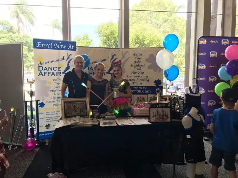 A Table With Balloons And A Sign That Says International Dance Affair — International Dance Affair In North Mackay, QLD