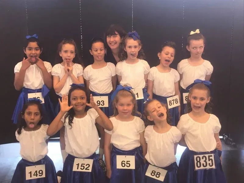 A Group Of Young Girls Wearing Blue Skirts With Numbers On Them — International Dance Affair In North Mackay, QLD