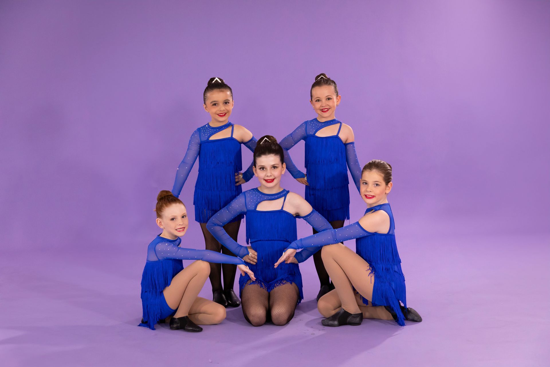 A Group Of Young Girls In Blue Dresses Are Posing For A Picture On A Purple Background — International Dance Affair In North Mackay, QLD