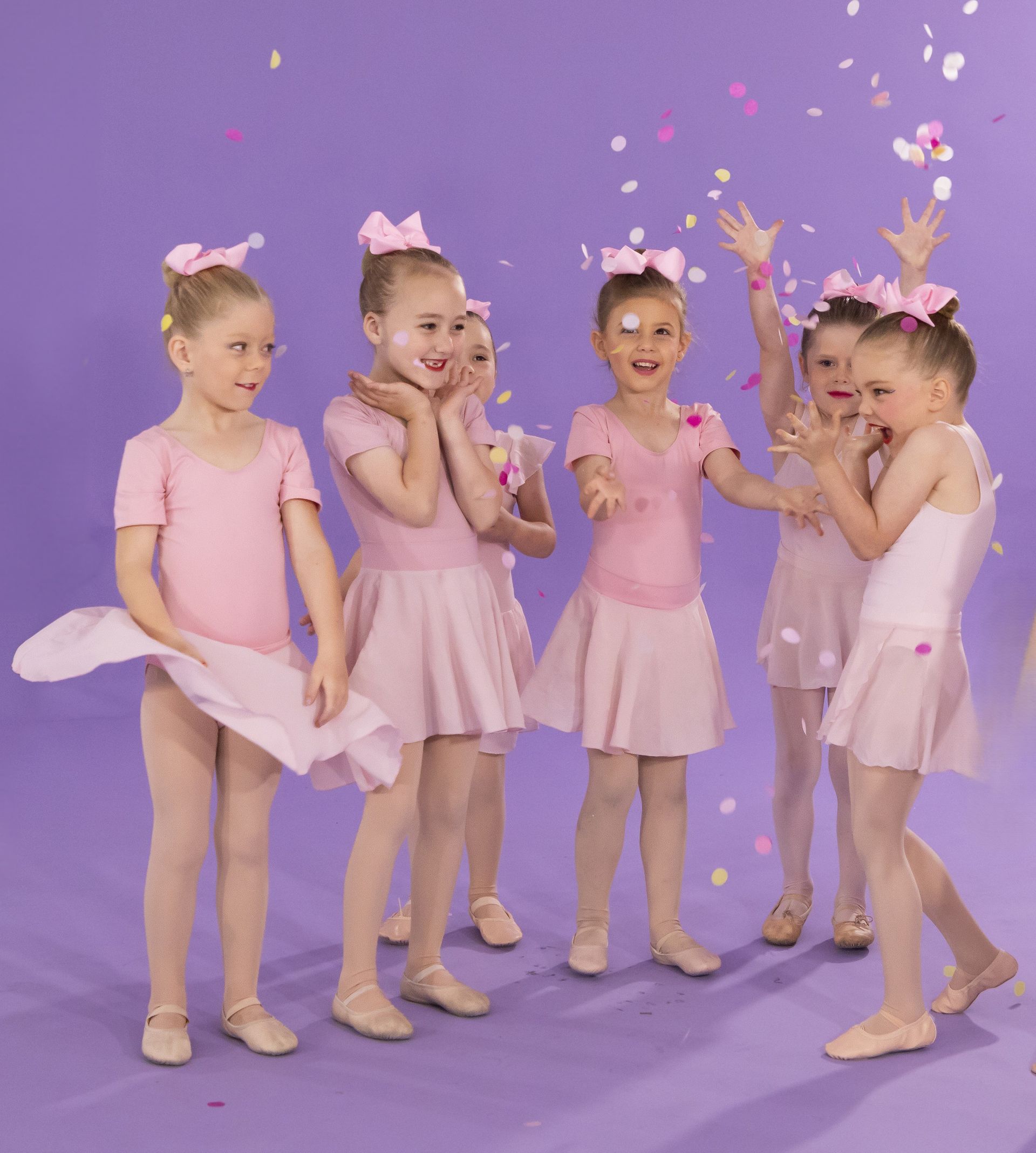 A Group Of Young Ballerinas Are Standing Next To Each Other On A Purple Background — International Dance Affair In North Mackay, QLD